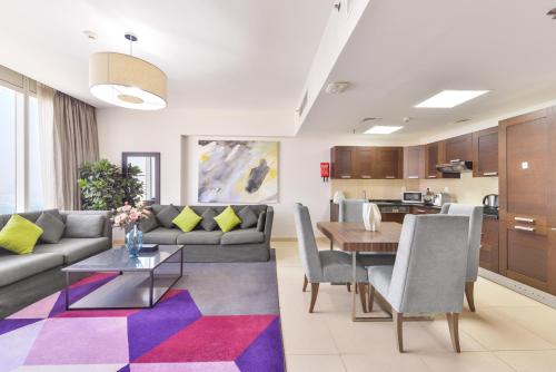 a living room with a couch and a table at Nassima Tower Hotel Apartments in Dubai