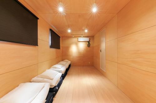 a row of beds in a room with a tv at trive osu west 最大9名宿泊可能 1台無料駐車場付き in Minami-sotoborichō