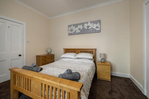 a bedroom with a bed with two pillows on it at Bright flat in Lauder Centre in Lauder