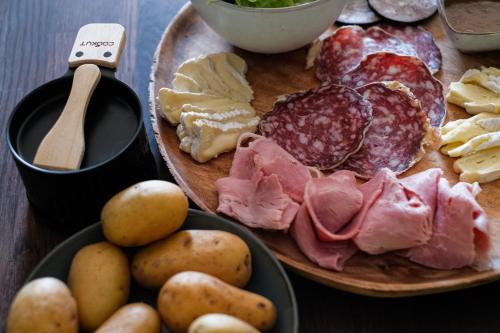 a plate of food with meat and potatoes on a table at Le Domaine de l'Hostellerie in Le Fresne-Camilly