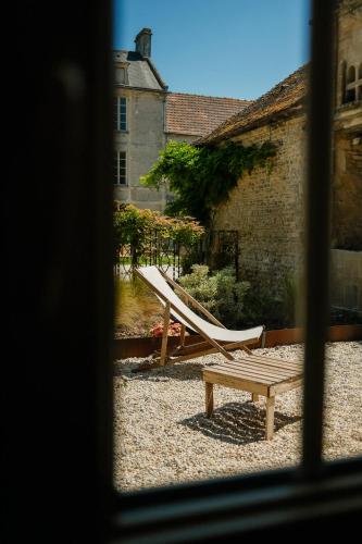 a view of a playground with a slide and a bench at Le Domaine de l'Hostellerie in Le Fresne-Camilly