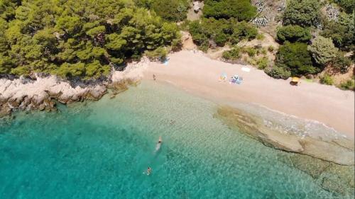 an aerial view of a beach with people in the water at Villa Majda at the Paradise beach in Murvica