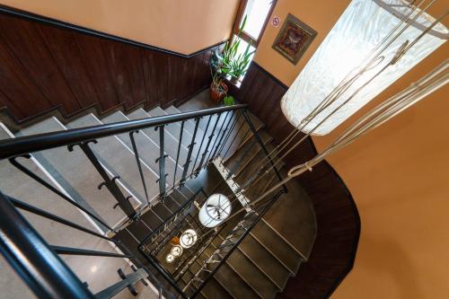 an overhead view of a spiral staircase with a clock at Hotel Ego - Free Parking - Top Central Location in Plovdiv