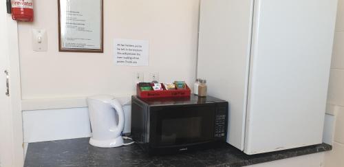 a microwave oven sitting on top of a counter at Roadside Motel in Waiouru
