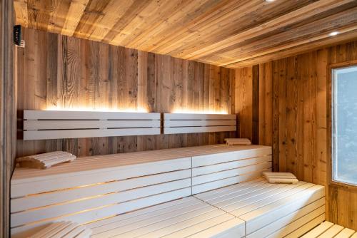 an empty sauna with wooden walls and ceilings at Hotel Tiroler Herz in Hinterhornbach