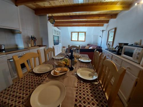 a dining room table with chairs and a table with food on it at Apartamento Monte Goriz in Candanchú
