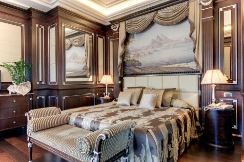 a bedroom with a large bed and a chair at Hotel Splendid in Baveno