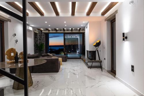 a living room with a couch and a table at Eloa Luxury Villa in Chania Town