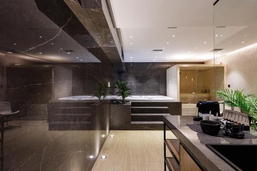 a large bathroom with a tub and a sink at Eloa Luxury Villa in Chania Town