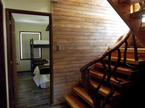a stairway in a room with a wooden wall at Centro Turistico Muscaria in Malalcahuello