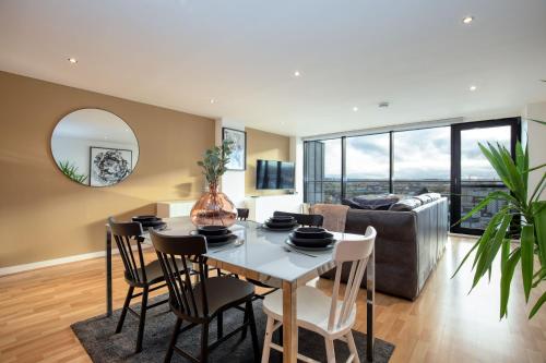 a kitchen and living room with a table and chairs at Riverview Apartments in Glasgow
