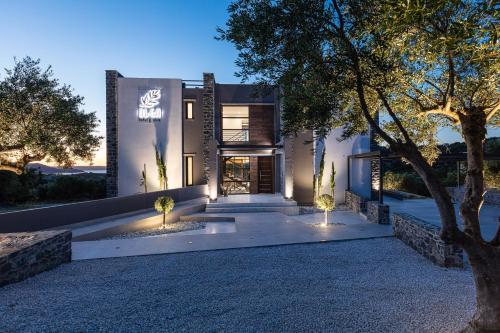 a home with lights on the side of a driveway at Eloa Luxury Villa in Chania Town