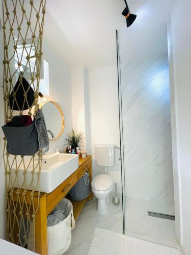 a bathroom with a sink and a shower at Chic sea front apartment with breathtaking Kotor Bay view in Donji Stoliv