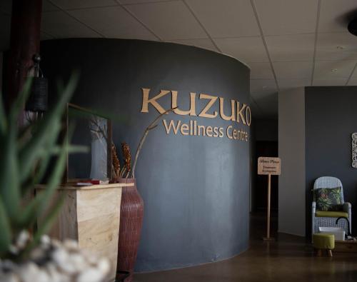 a wall with a wellness center sign on it at Kuzuko Lodge in Addo