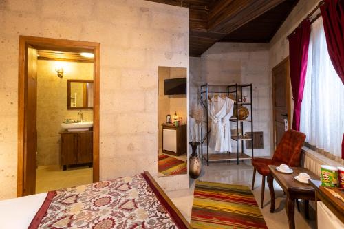 a bedroom with a bathroom with a sink and a room at Lord of Cappadocia Hotel in Goreme