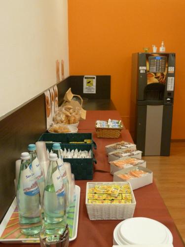 a table with food and drinks on top at Hotel Fiera in Bolzano