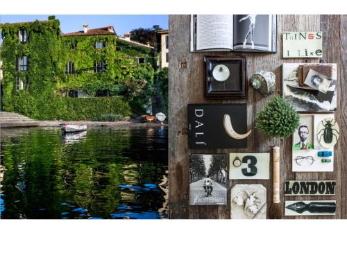 a wall with signs on it next to a body of water at Pescallo Apartments in Bellagio