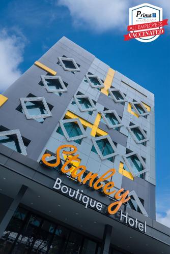 a building with a sign on the side of it at Stanley Wahid Hasyim Jakarta in Jakarta