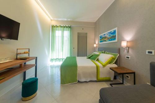 a hotel room with a bed and a television at B&B La Piazzetta in Ischia Town