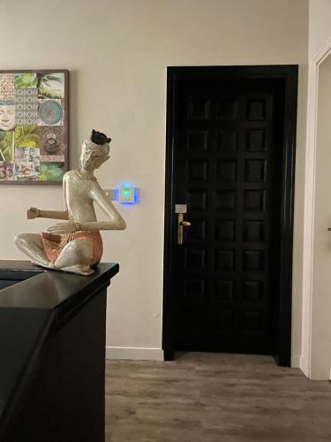 a statue of a woman sitting on a counter next to a door at Holiday Thea & Residence in Gabicce Mare