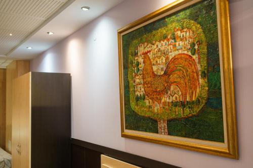 a painting of a peacock hanging on a wall at Hotel Ego - Free Parking - Top Central Location in Plovdiv