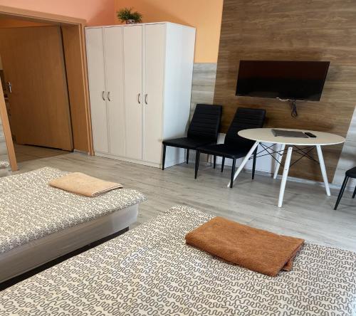 Pokój z dwoma łóżkami, stołem i telewizorem w obiekcie Eldom-Noclegi Rogozińska 29E w Wągrowcu
