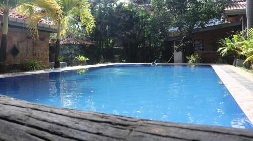 a large blue swimming pool in a yard at Pavana Hotel in Negombo