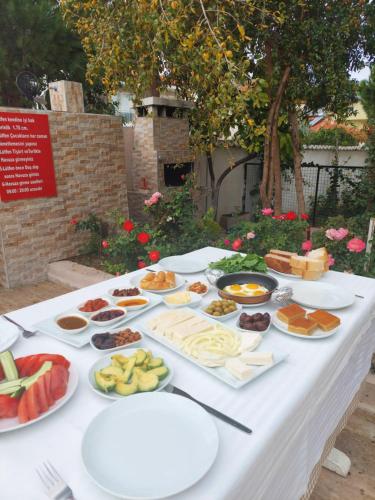 a table with many plates of food on it at Eser Apart Dalyan in Ortaca