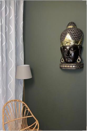 a statue of a head hanging on a wall at Holiday Thea & Residence in Gabicce Mare