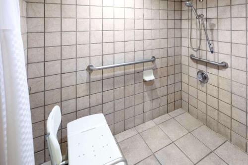 a bathroom with a toilet and a shower at Days Inn by Wyndham Tupelo in Tupelo