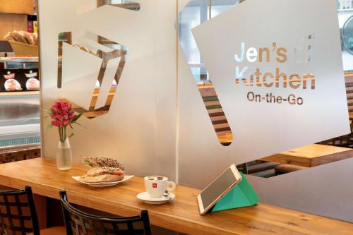 a table with a laptop and a cup of coffee at Jen Maldives Male by Shangri-La in Male City