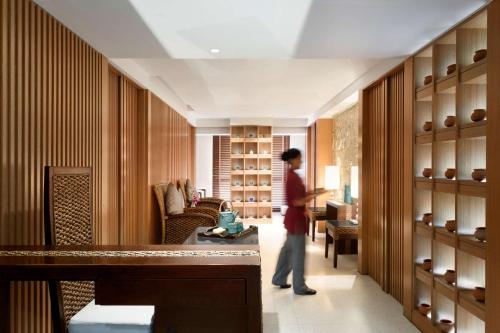 a person standing in a room with a closet at Jen Maldives Male by Shangri-La in Male City