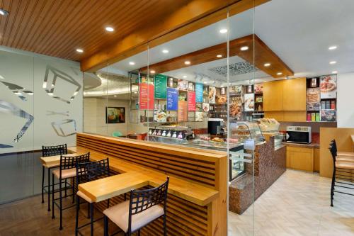 a restaurant with tables and chairs and a counter at Jen Maldives Male by Shangri-La in Male City