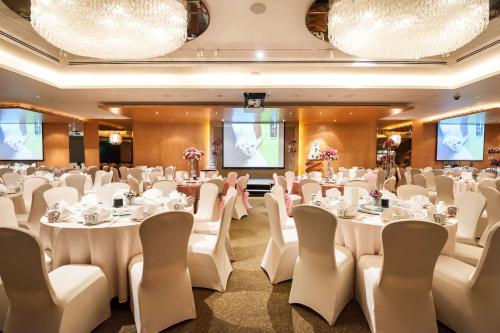 a banquet hall with white tables and chairs at JEN Singapore Tanglin by Shangri-La in Singapore