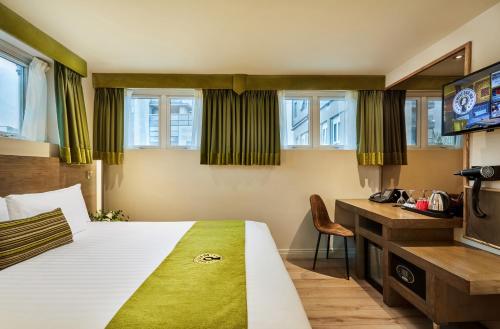 a hotel room with a bed and a desk at Temple Bar Inn in Dublin