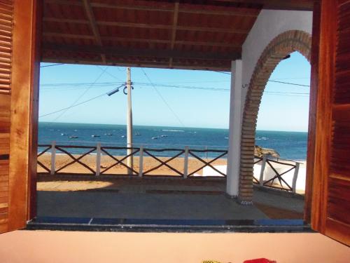 a window view of the ocean from a house at CHALÉ COQUEIROS in Icapuí