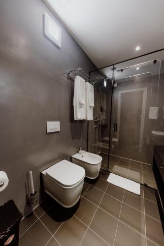 a bathroom with a toilet and a shower at Habitat Hotel Tirana in Tirana