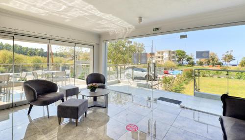 a living room with a glass table and chairs at Botanica Luxury Suites in Neos Marmaras