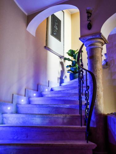 a set of stairs in a building with blue lighting at Castello di Pandora in Nepi