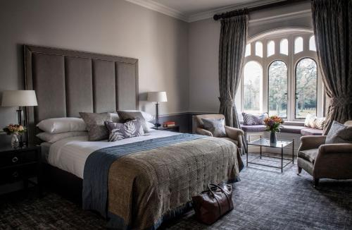 a bedroom with a large bed and a large window at Rookery Hall Hotel & Spa in Nantwich