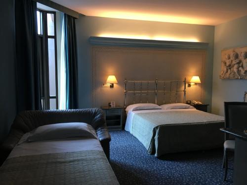 Un pat sau paturi într-o cameră la Guglielmotel