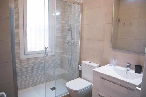 a bathroom with a shower and a toilet and a sink at Homeloving apartment Bilbao centre with Parking in Bilbao