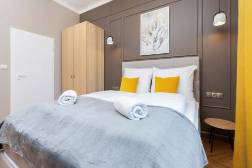 a bedroom with a large bed with towels on it at Sopot RIVOLI Apartments by Renters in Sopot