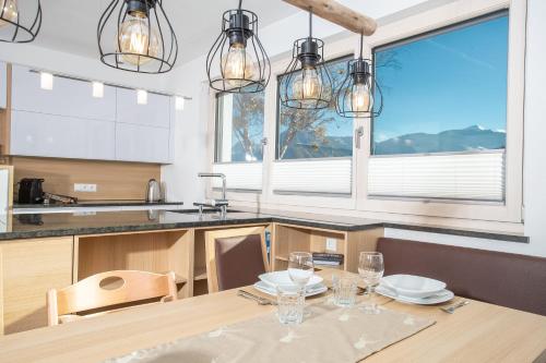 a kitchen with a table with glasses on it at Apart Dahoam in Wiesing