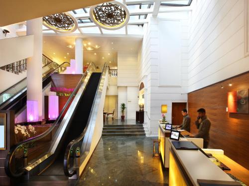 an escalator in the lobby of a hotel at Village Hotel Albert Court by Far East Hospitality in Singapore