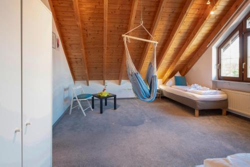 a room with a hammock hanging from a wooden ceiling at FeWo Immenstaad 2 in Immenstaad am Bodensee