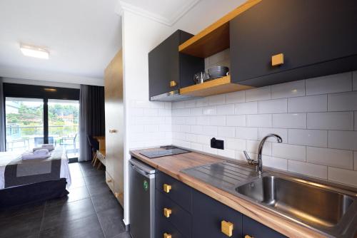 a kitchen with a sink and a counter top at Botanica Luxury Suites in Neos Marmaras