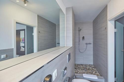 a bathroom with a shower and a toilet in it at Hotel Schlemmer in Montabaur