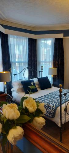 a bedroom with a bed with white flowers on it at Park Dene Room only in Whitby
