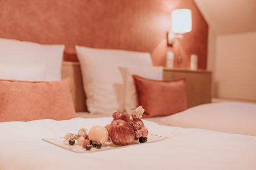 a plate of food on top of a bed at PANORAMA Hotel Heimbuchenthal in Heimbuchenthal